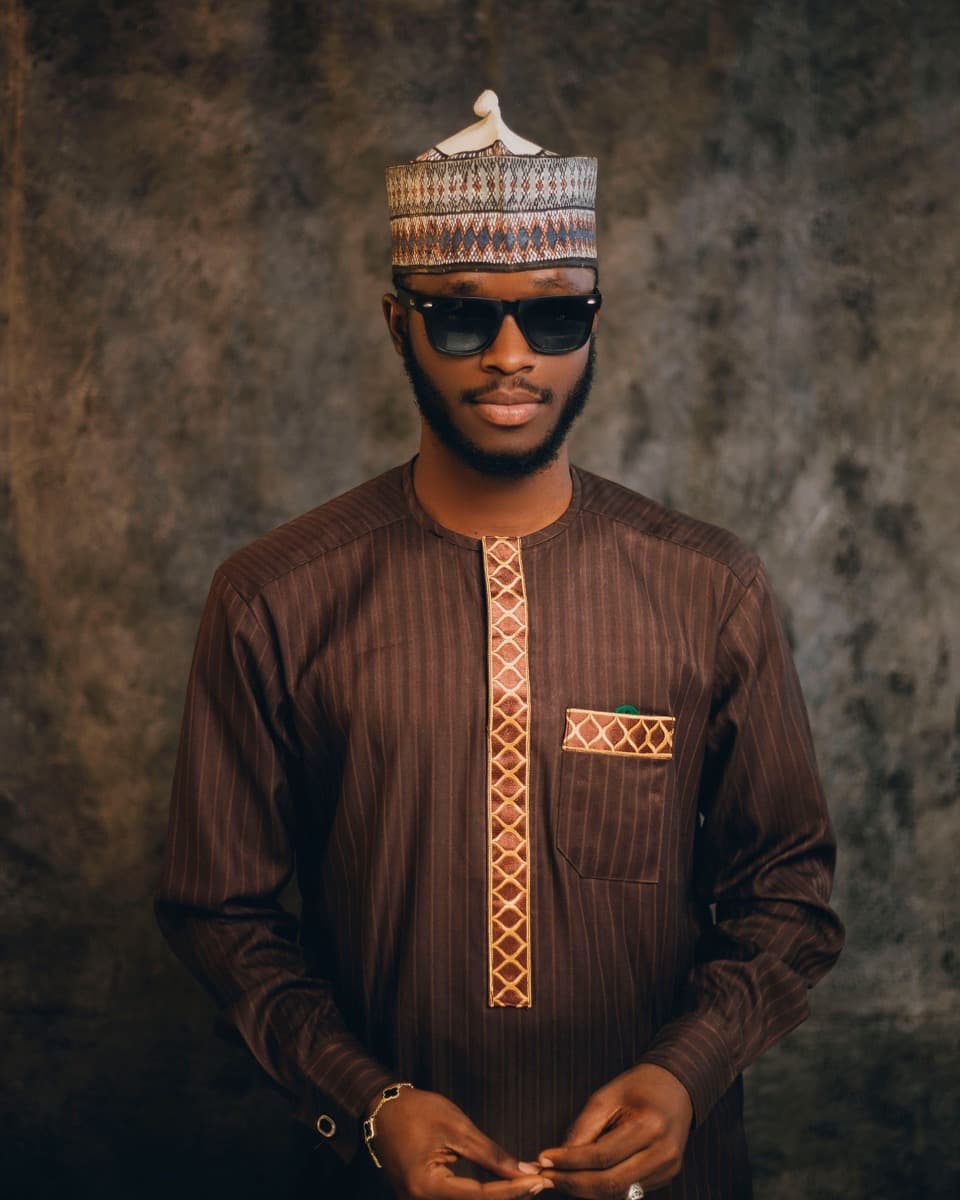 Close-up of a mandarin-collar senator wear top with subtle embroidery down the front placket